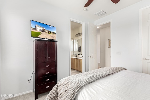 carpeted bedroom with ceiling fan and ensuite bathroom