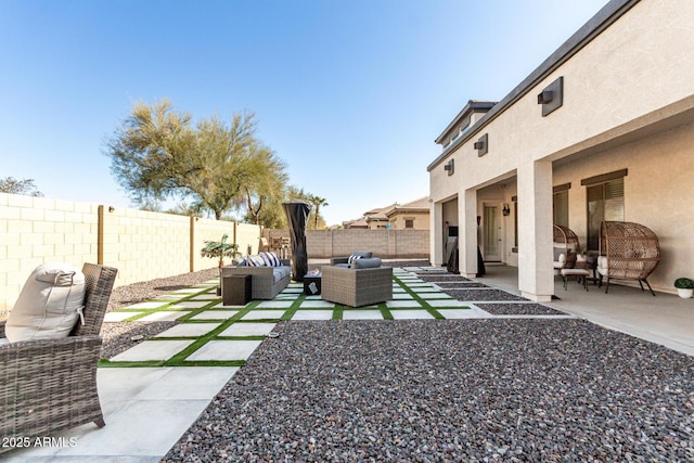 view of yard with an outdoor living space and a patio area