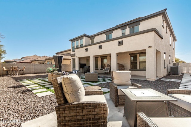 rear view of property with an outdoor hangout area, central AC, and a patio area