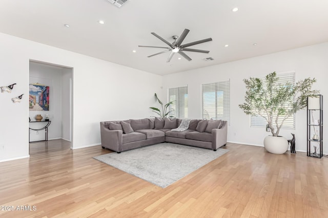 living room featuring ceiling fan and light wood-type flooring