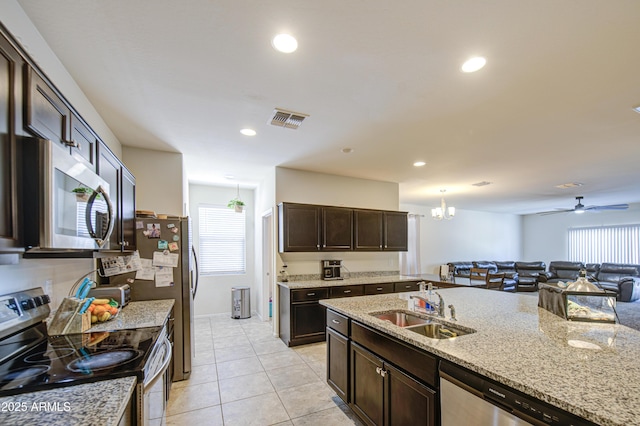 10856 E Primrose Ct, Florence, AZ 85132 - kitchen with dark brown cabinets, visible vents, a sink, stainless steel appliances, and open floor plan