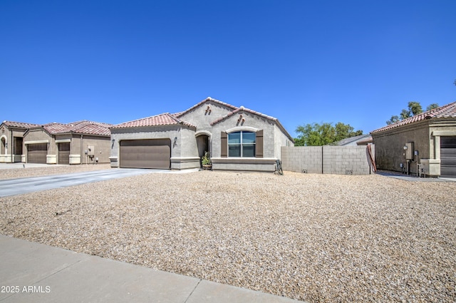 10856 E Primrose Ct, Florence, AZ 85132 - view of front of house with a tiled roof, an attached garage, fence, concrete driveway, and stucco siding