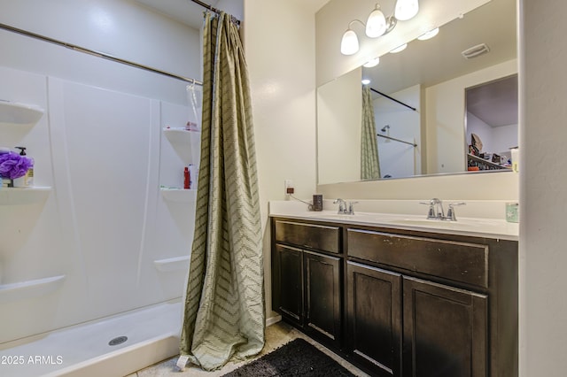 10856 E Primrose Ct, Florence, AZ 85132 - bathroom with a sink, visible vents, double vanity, and a stall shower