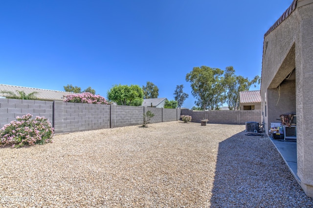 10856 E Primrose Ct, Florence, AZ 85132 - view of yard featuring a fenced backyard and central AC unit
