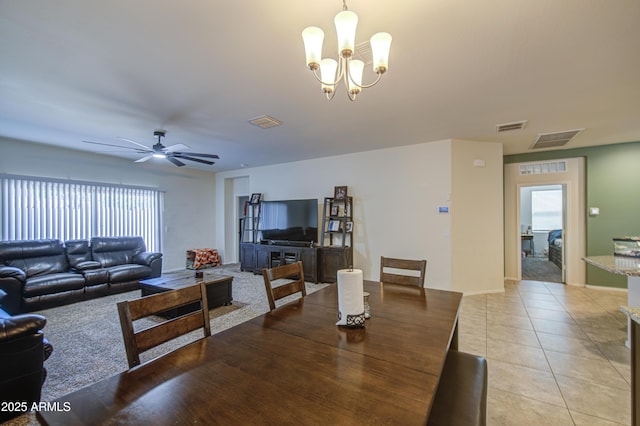 10856 E Primrose Ct, Florence, AZ 85132 - dining area with light tile patterned floors, visible vents, and ceiling fan with notable chandelier