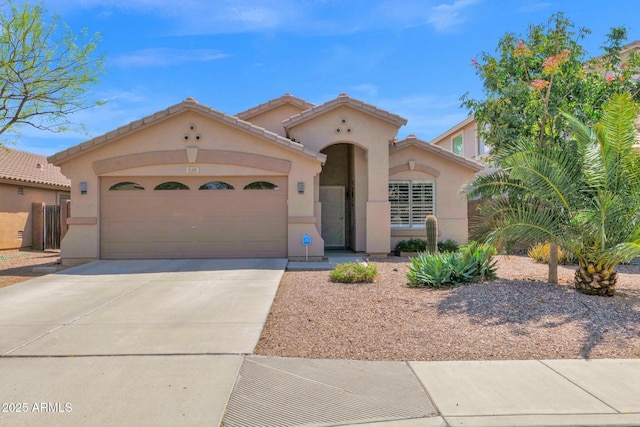 15391 W Yucatan Dr, Surprise, AZ 85379 - mediterranean / spanish home with stucco siding, concrete driveway, an attached garage, and a tiled roof