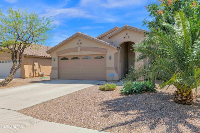15391 W Yucatan Dr, Surprise, AZ 85379 - mediterranean / spanish-style home featuring stucco siding, concrete driveway, an attached garage, and a tile roof