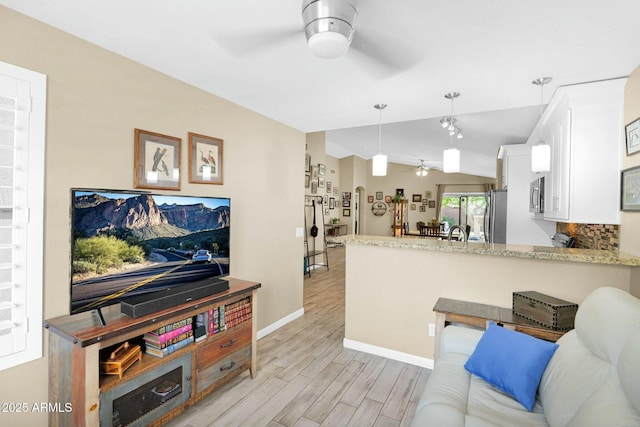 15391 W Yucatan Dr, Surprise, AZ 85379 - living room with ceiling fan, light wood-style flooring, lofted ceiling, and baseboards