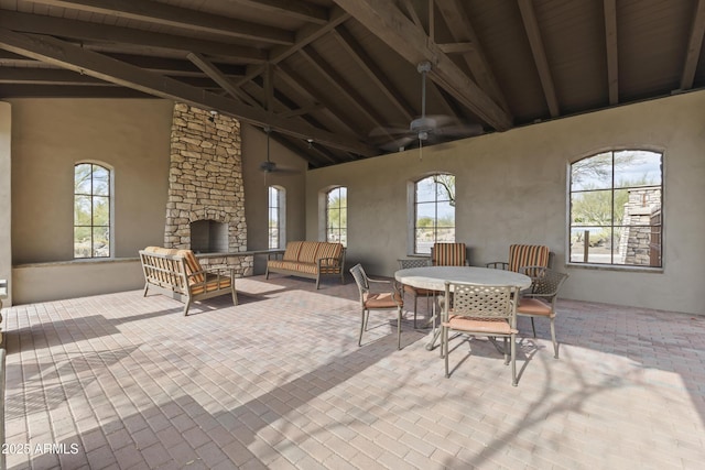 view of patio / terrace featuring an outdoor living space with a fireplace and ceiling fan