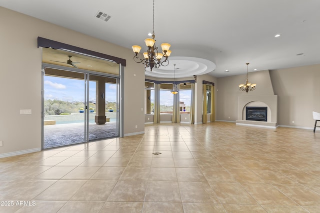 unfurnished living room featuring light tile patterned floors and ceiling fan with notable chandelier