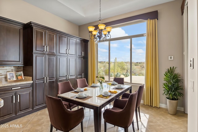 dining space with light tile patterned floors and a chandelier