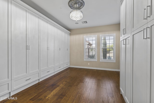 interior space with dark hardwood / wood-style floors and a notable chandelier