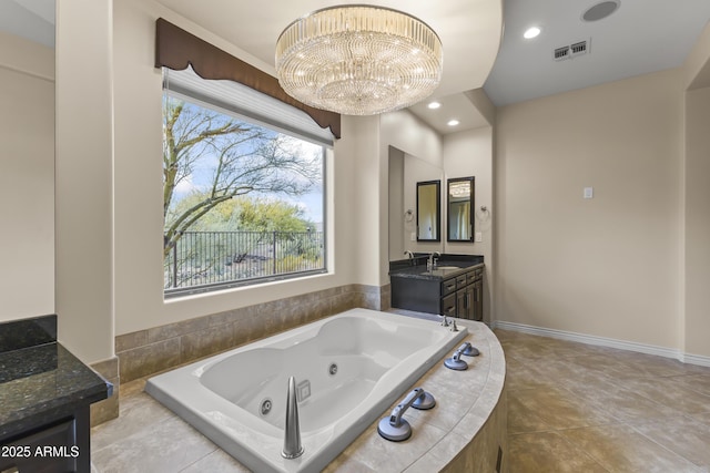 bathroom featuring tile patterned floors, tiled tub, vanity, and a chandelier