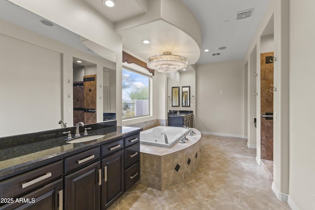 bathroom with tile patterned floors, vanity, separate shower and tub, and a notable chandelier