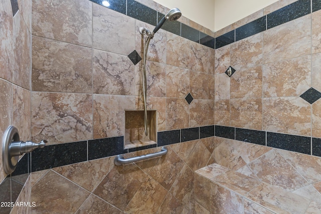 interior details featuring a tile shower