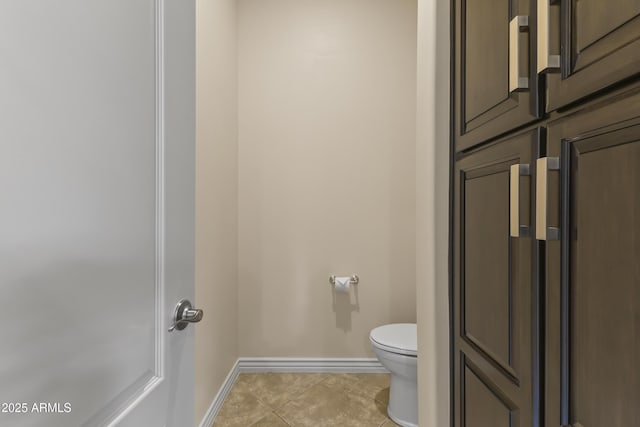 bathroom with toilet and tile patterned floors