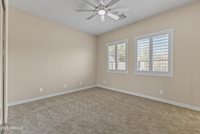 carpeted empty room featuring ceiling fan