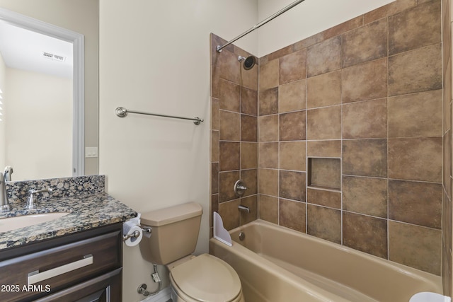 full bathroom featuring vanity, toilet, and tiled shower / bath