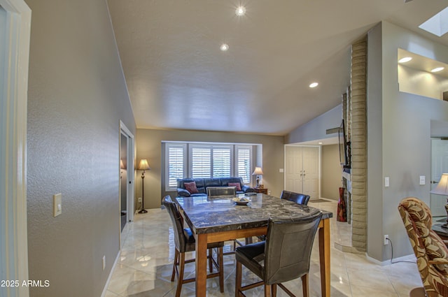 tiled dining area with lofted ceiling