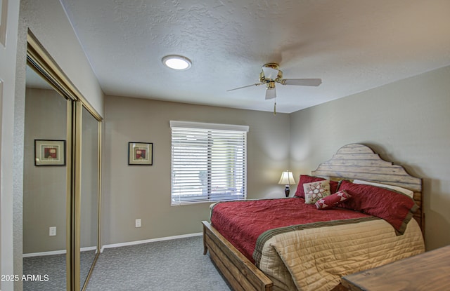 carpeted bedroom featuring ceiling fan, a textured ceiling, and a closet