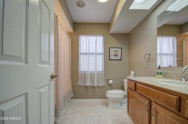 bathroom with vanity, tile patterned floors, and toilet