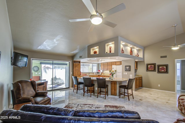 living room featuring lofted ceiling, a textured ceiling, and ceiling fan