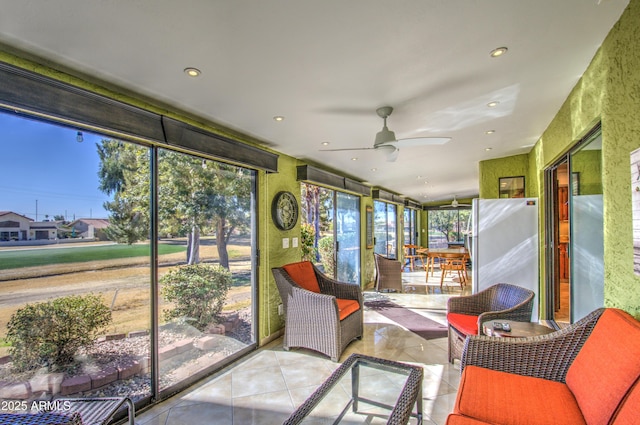 sunroom / solarium featuring ceiling fan