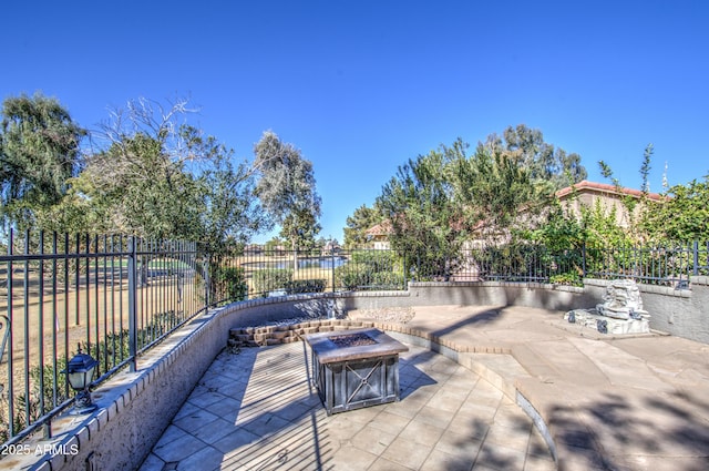 view of patio with a fire pit