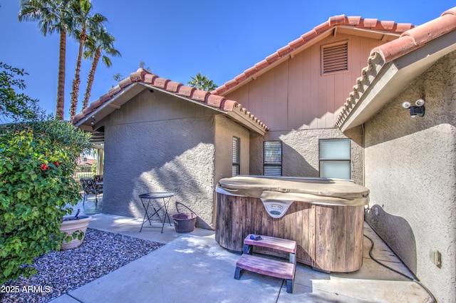 exterior space with a hot tub