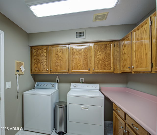 washroom featuring cabinets, light tile patterned flooring, and independent washer and dryer