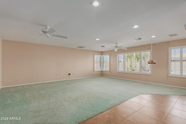 carpeted spare room featuring ceiling fan