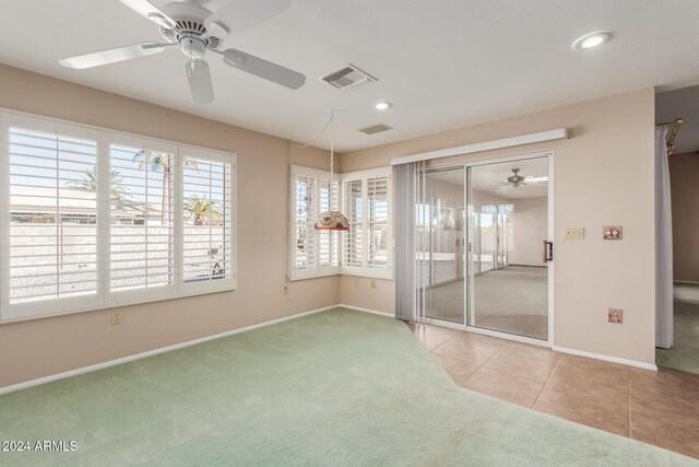 carpeted empty room with ceiling fan