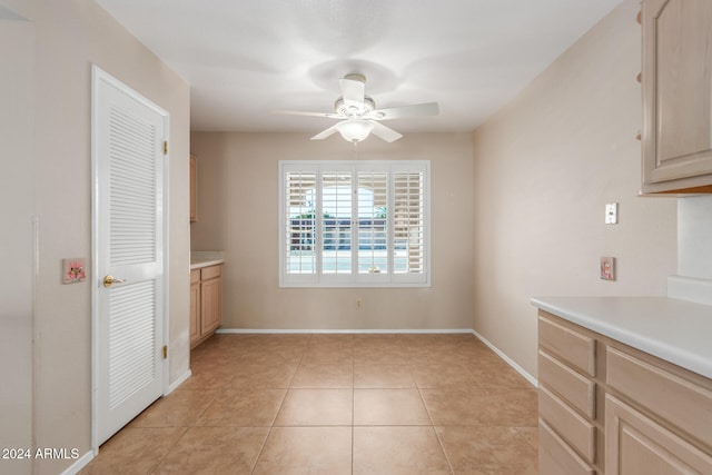 unfurnished dining area featuring ceiling fan and light tile patterned floors