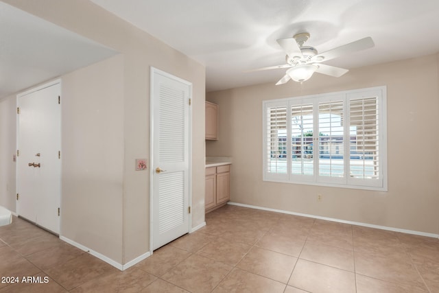 interior space with ceiling fan and light tile patterned floors