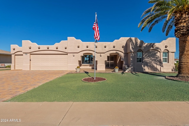 southwest-style home with a garage and a front yard