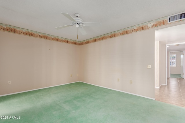 carpeted empty room featuring ceiling fan