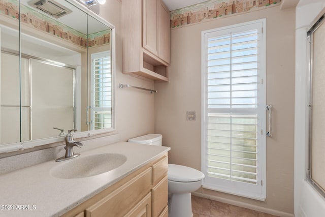 bathroom with an enclosed shower, vanity, tile patterned floors, and toilet