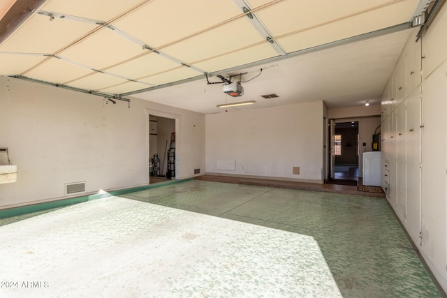 garage with washer / dryer and a garage door opener