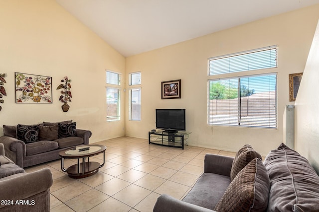 tiled living room featuring plenty of natural light and high vaulted ceiling