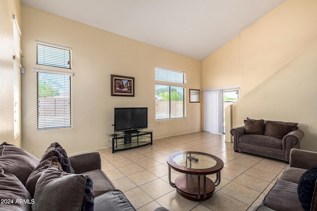 living room featuring high vaulted ceiling and light tile patterned floors