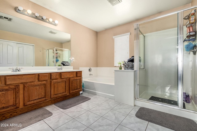 bathroom with tile patterned floors, separate shower and tub, and vanity