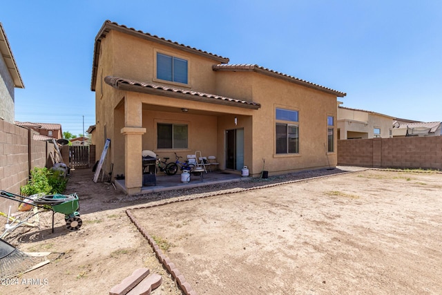 back of property with a patio area