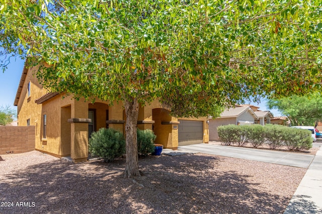 obstructed view of property with a garage