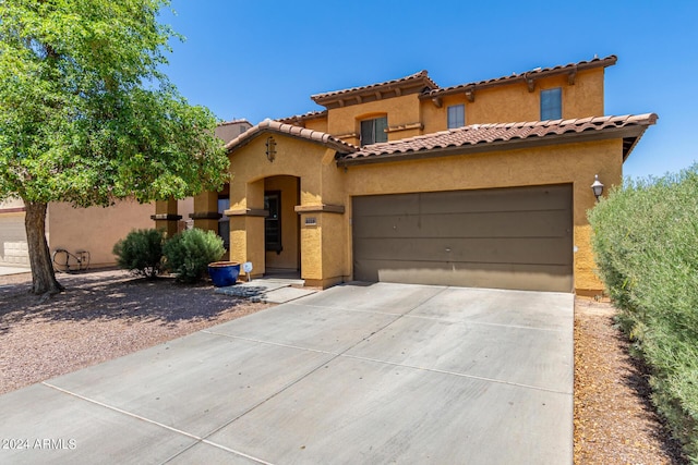 mediterranean / spanish-style house with a garage