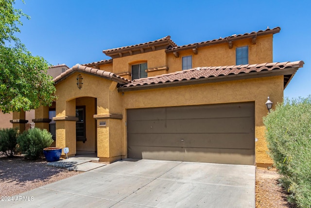 mediterranean / spanish house featuring a garage