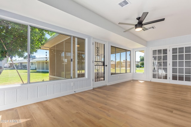 unfurnished sunroom featuring ceiling fan