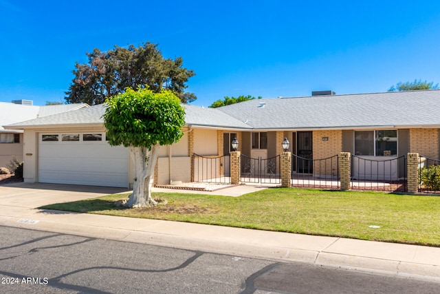 ranch-style house with a front yard and a garage