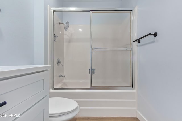 full bathroom with toilet, vanity, and combined bath / shower with glass door