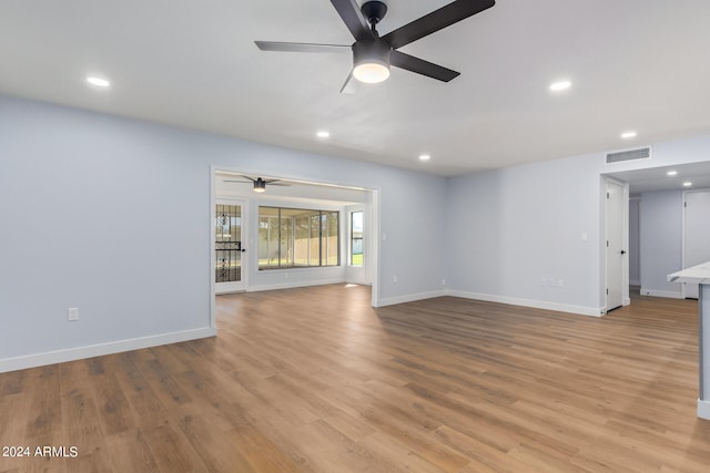 empty room with light hardwood / wood-style flooring and ceiling fan