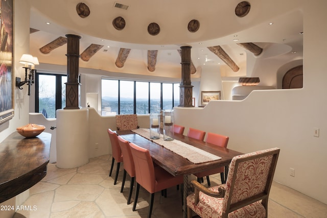 dining area with beamed ceiling and a water view